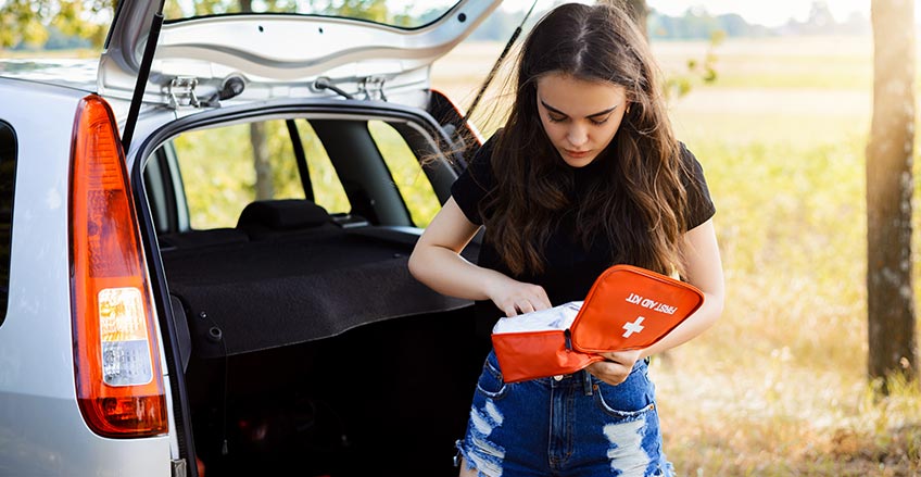 Emergency kit with tools and supplies in car trunk