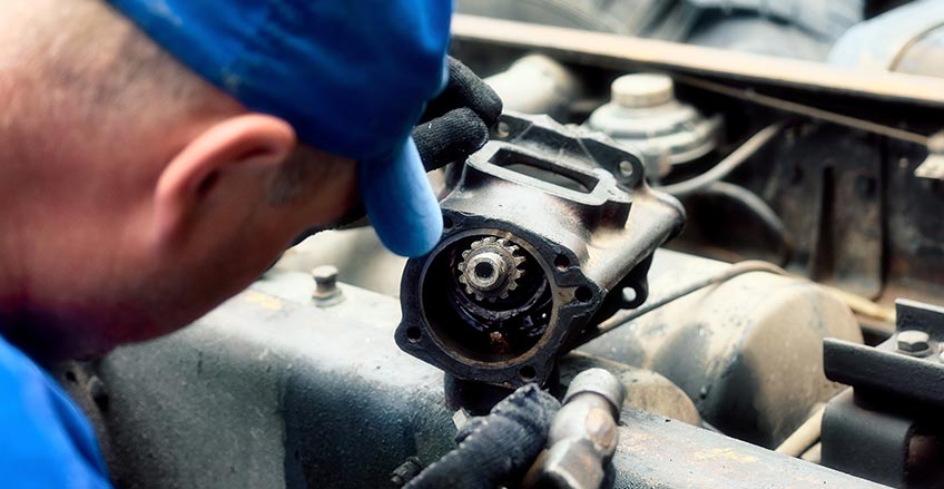 Professional mechanic working on a car transmission