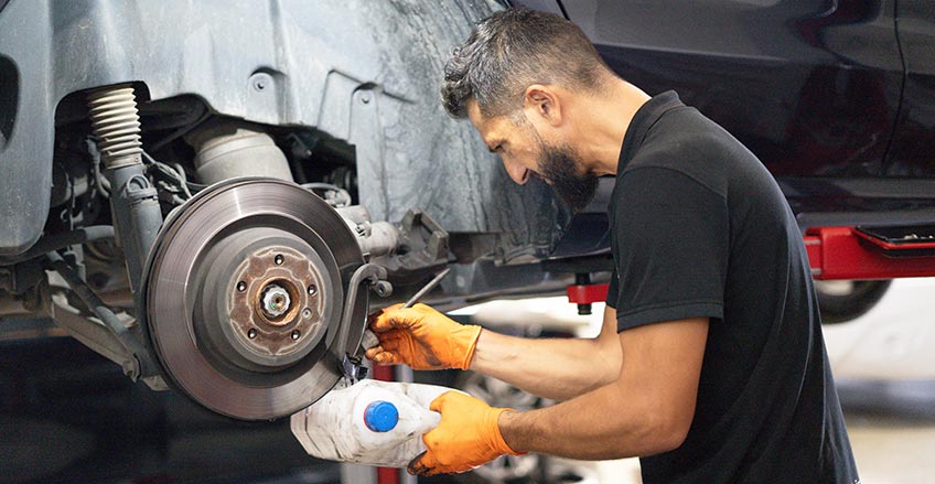 Auto mechanic performing a brake inspection in Burnaby BC